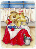 Two teddy bears at a table with red tablecloth, glasses, and a bottle, in a room with curtains.