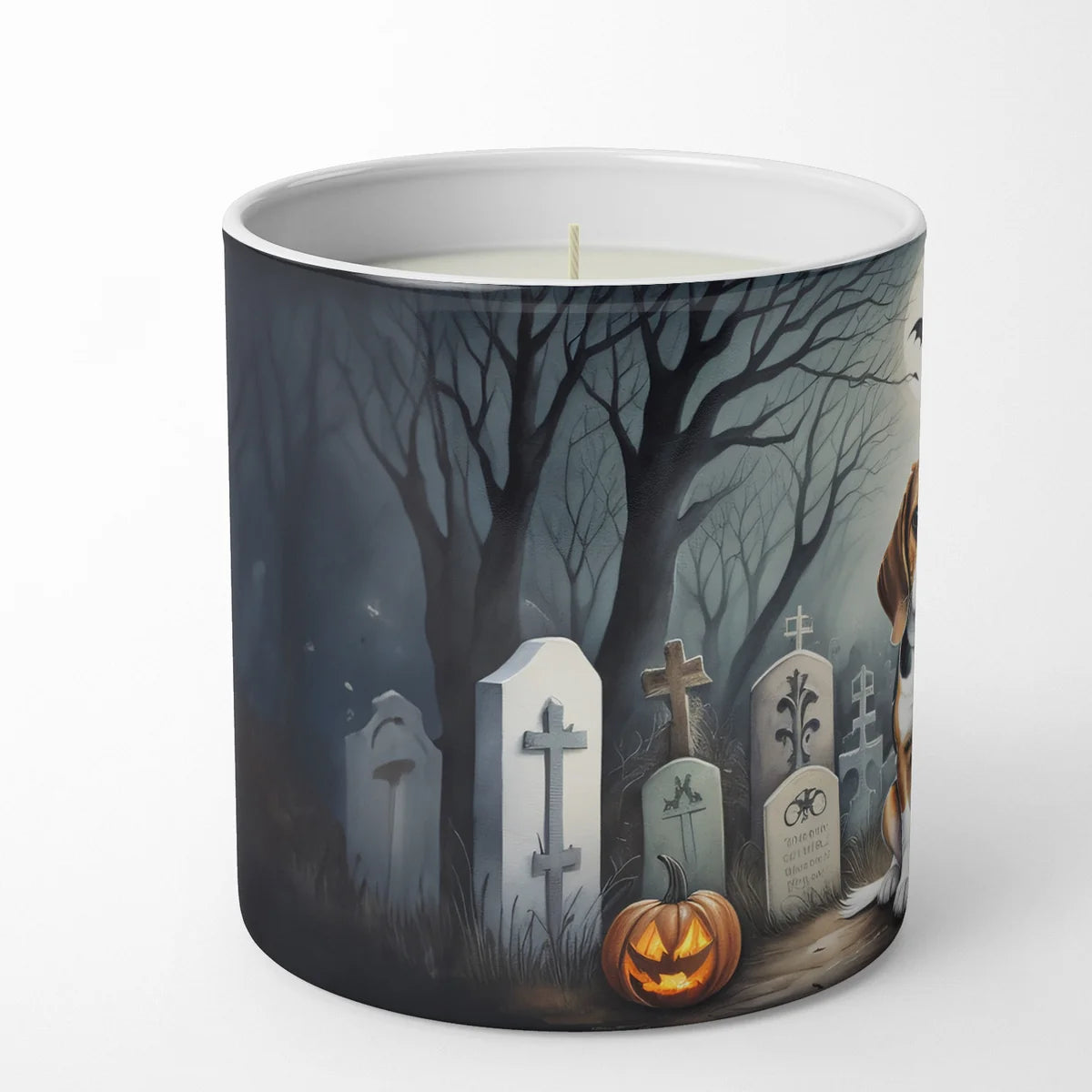 Candle with a Halloween-themed design of a graveyard on a white background