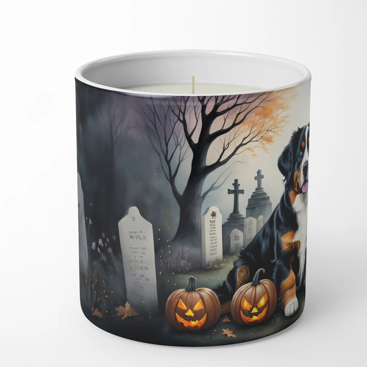 Candle with a Halloween-themed design featuring a dog, pumpkins, and gravestones on a white background.