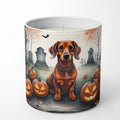 Candle with a dachshund and Halloween pumpkins design on a white background