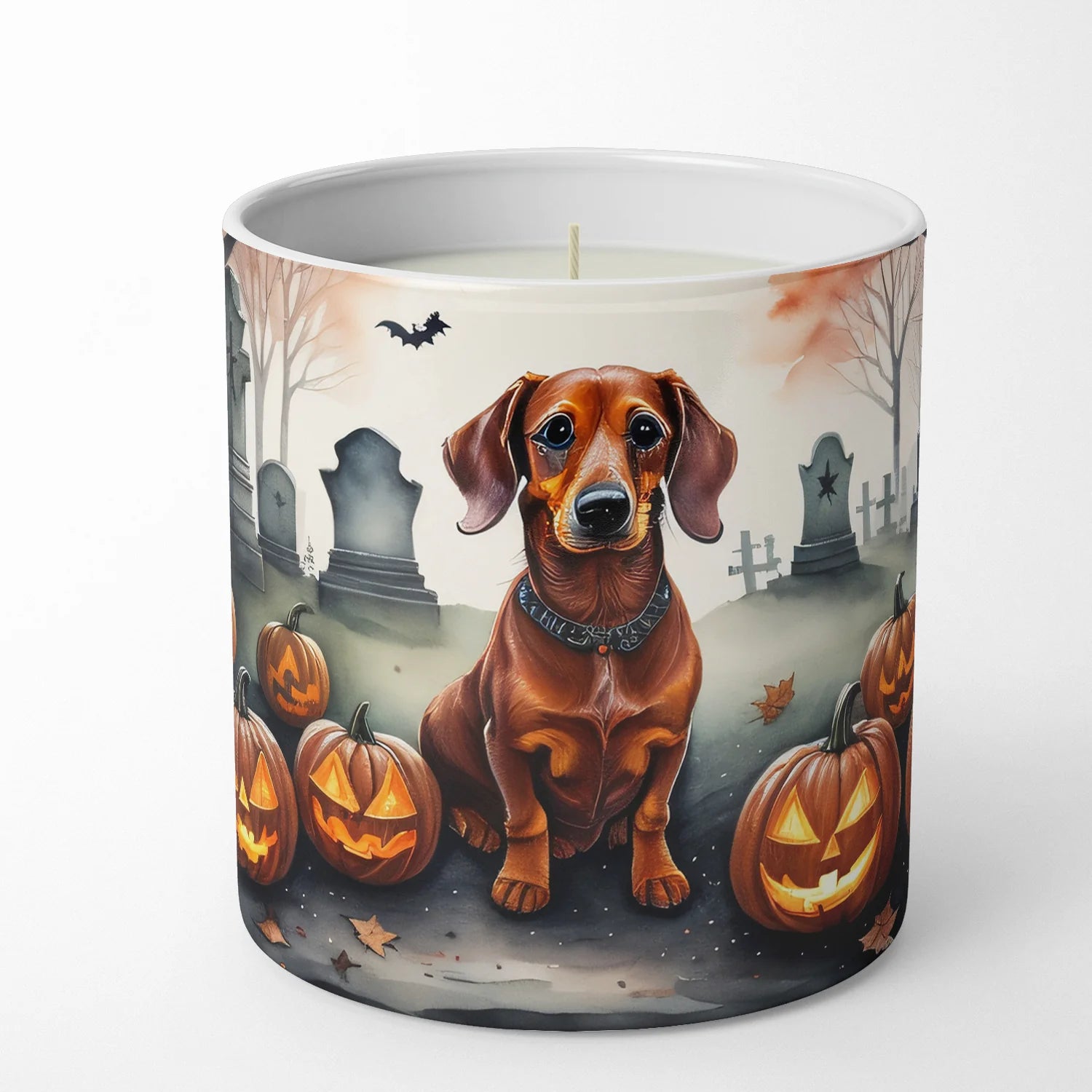 Candle with a dachshund and Halloween pumpkins design on a white background