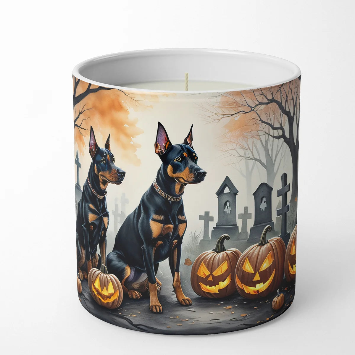 Candle with Halloween design featuring dogs and pumpkins in a cemetery.