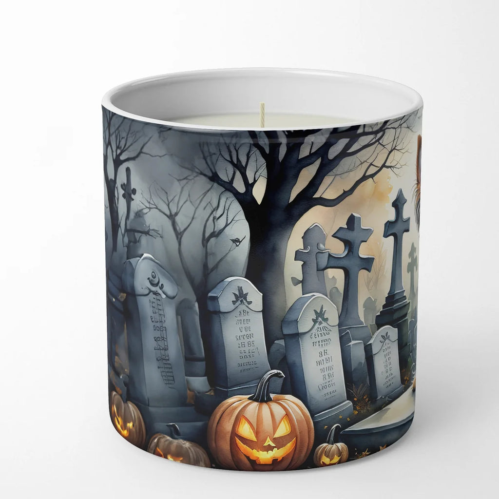 A white ceramic candle jar featuring a printed Halloween graveyard design with tombstones, bare trees, jack-o'-lanterns, and a pale moonlit sky.