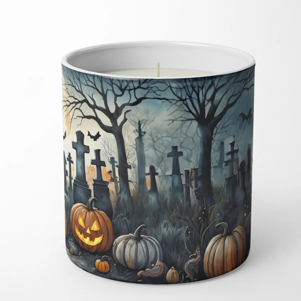 A white ceramic candle jar featuring a detailed Halloween graveyard illustration with pumpkins, tombstones, bare trees, and bats, shown on a clean white background.