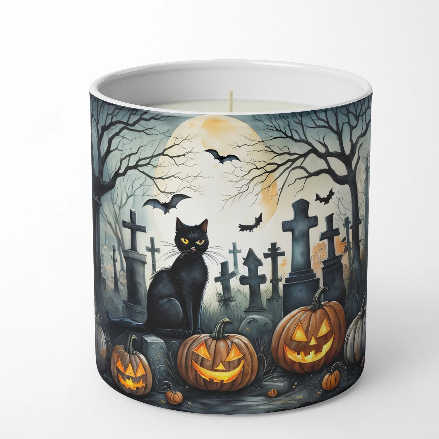 Candle with Halloween-themed design featuring a black cat, pumpkins, and bats in a graveyard.