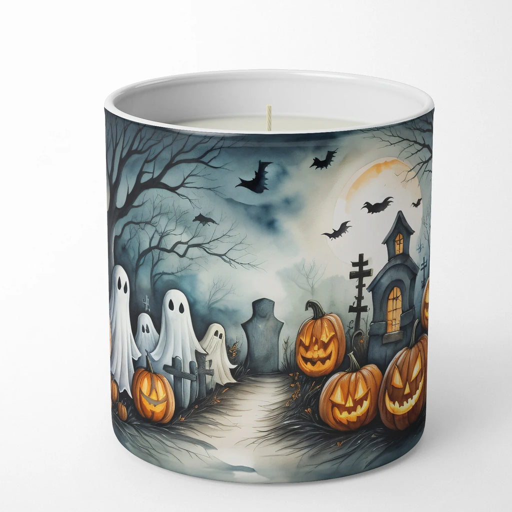 A white wax candle in a cylindrical container with a printed Halloween scene on the outside, featuring ghosts, pumpkins, bats, a haunted house, and a full moon against a dark blue sky.