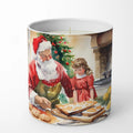 Candle with a design of Santa Claus and a child baking cookies in front of a Christmas tree.