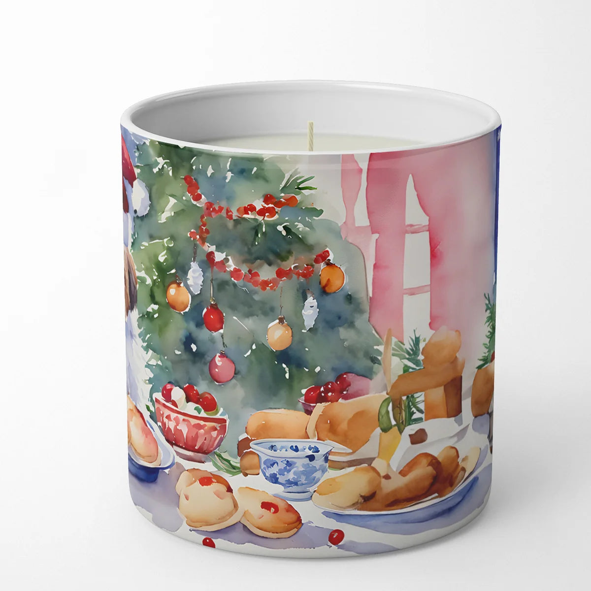 Candle with festive design of cookies, tree, and presents on a white background