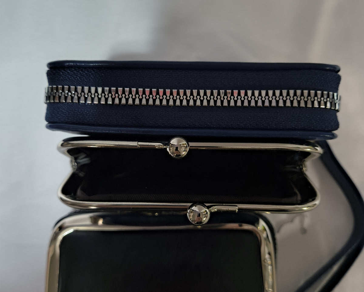 A navy blue leather zip-around clutch bag with a silver-tone metal kiss-lock frame and clear rhinestone closures, shown open against a light gray background.
