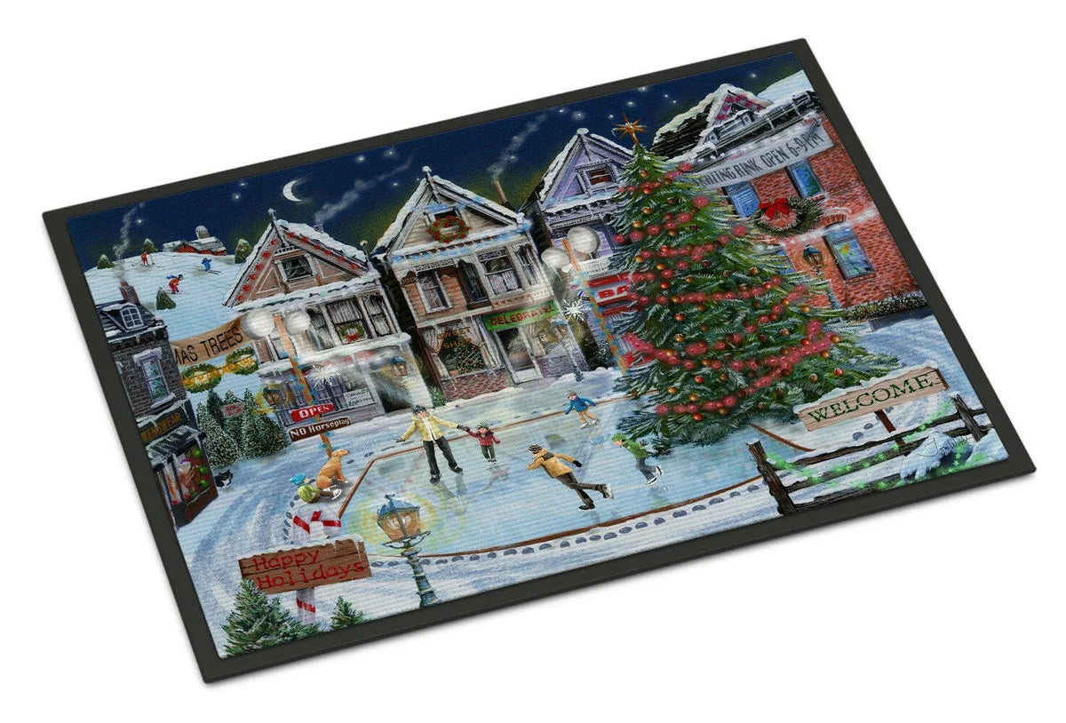 A rectangular doormat with a black border featuring a detailed winter village scene. The illustration shows snow-covered houses, a decorated Christmas tree, people ice skating in a town square, and a dark night sky with a crescent moon.