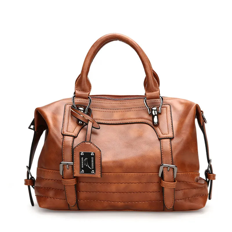 Brown leather handbag with multiple straps on a white background