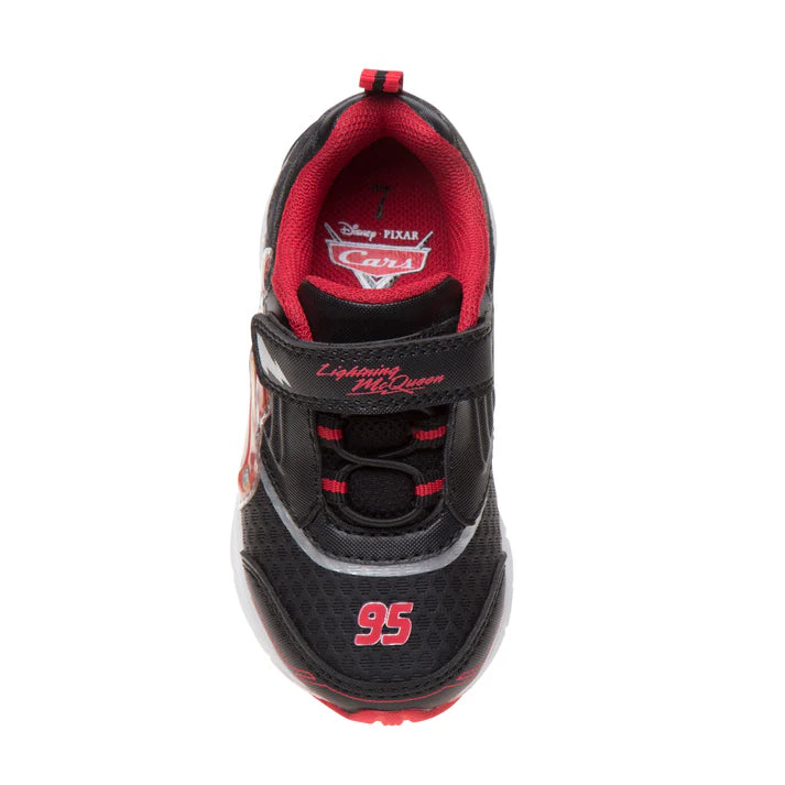 A single children's sneaker shown from a top-down view on a white background. The shoe is primarily black with bright red accents, including a red interior lining, red '95' graphic on the toe area, and red 'Lightning McQueen' text on the strap.